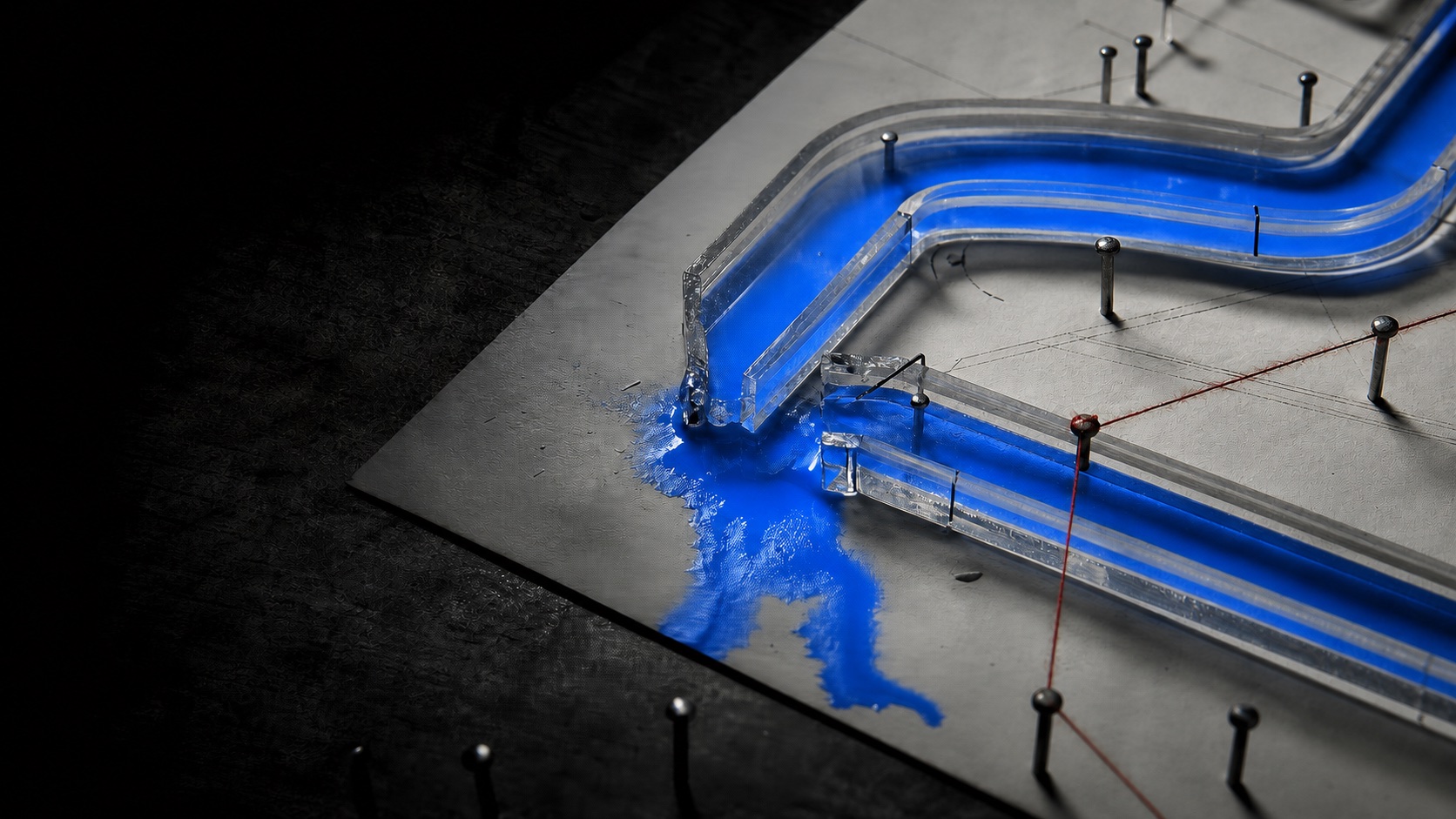 A transparent diagnostic channel leaking a cobalt-blue signal at a broken junction